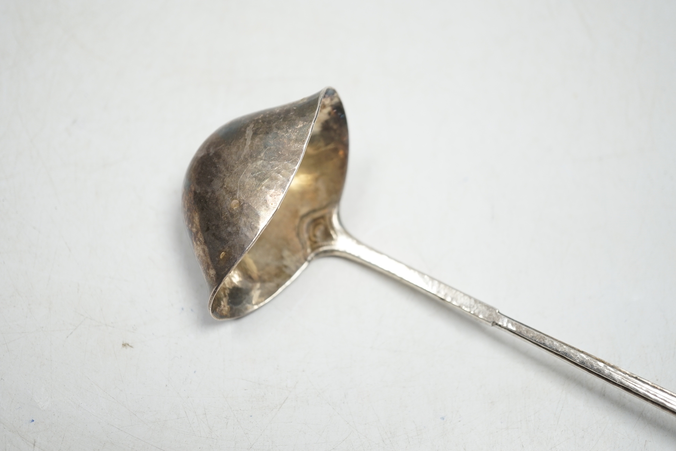 A George V Arts & Craft silver cream ladle by Omar Ramsden, London, 1934, 16.7cm, 49 grams.